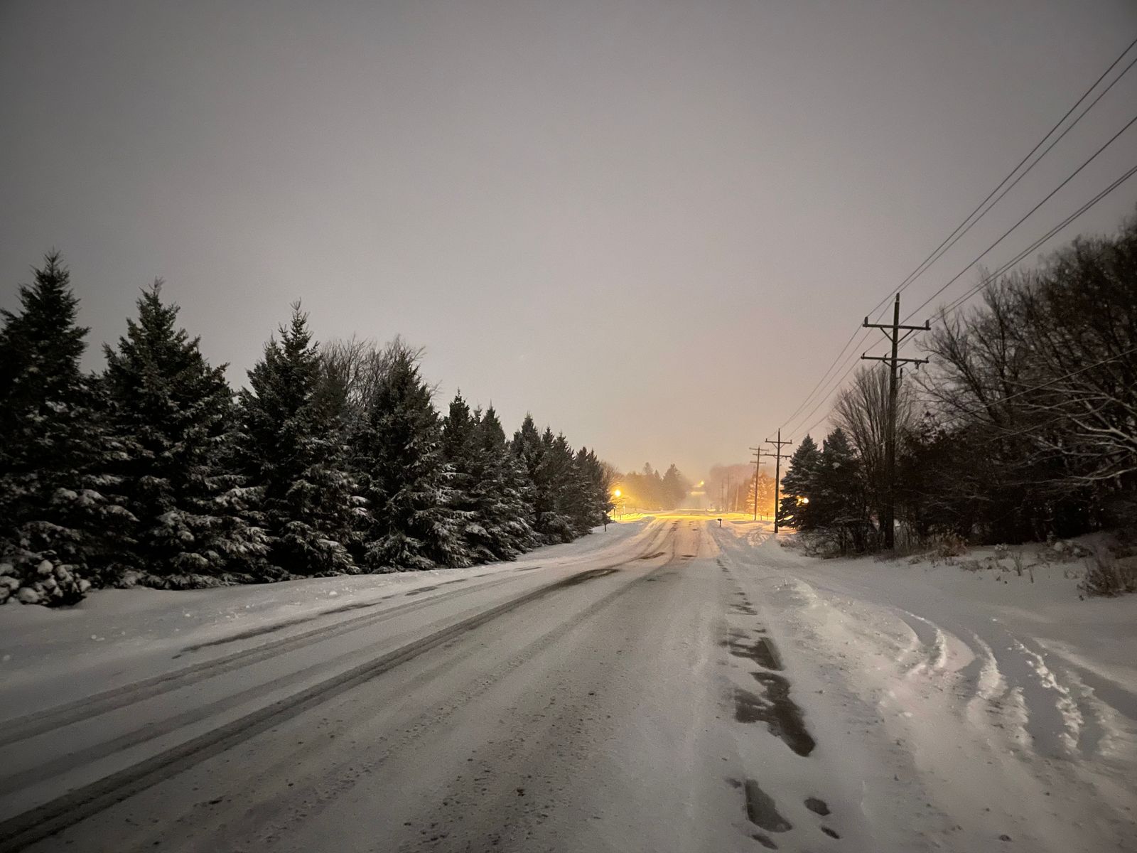 Road covered in snow at night
