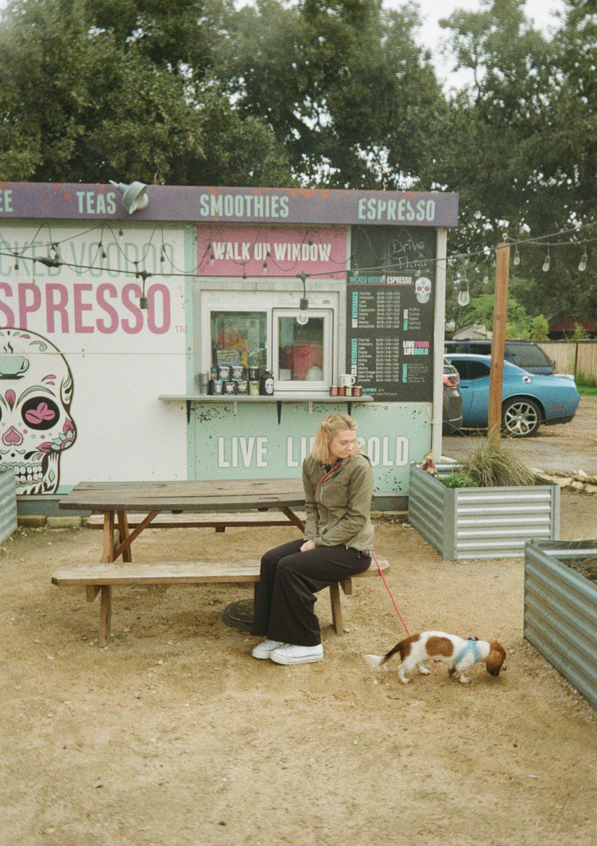 My wife and dog sitting in front of a coffee shop