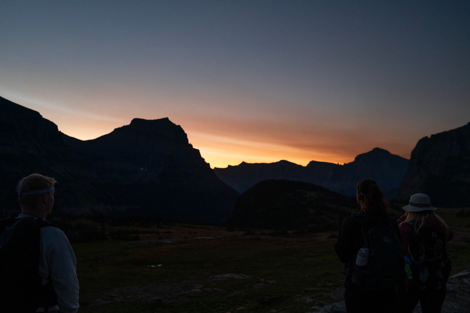 A group of hikers watching a sunrise