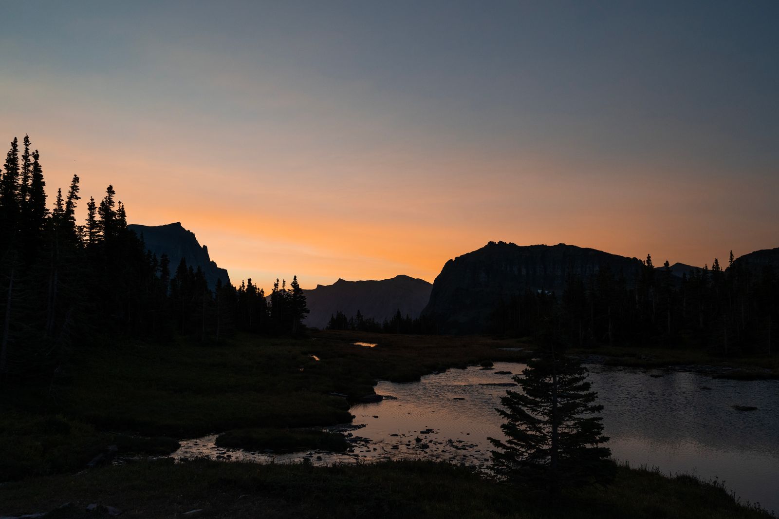 Sunrise casting light over a small pond