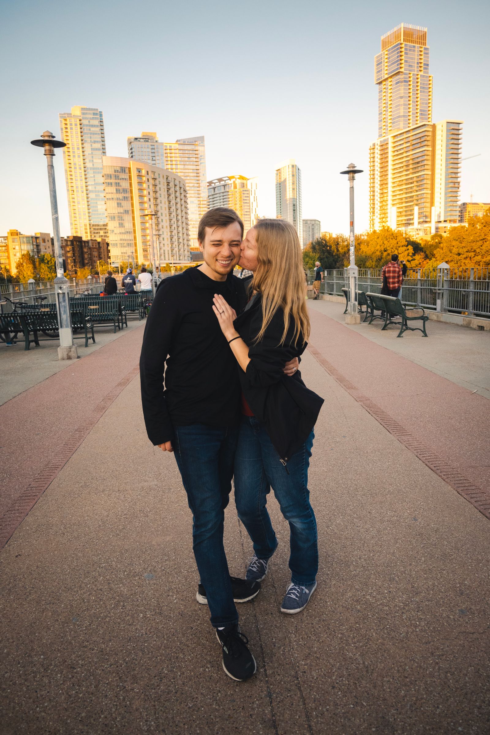 Two people on a pedestrian bridge