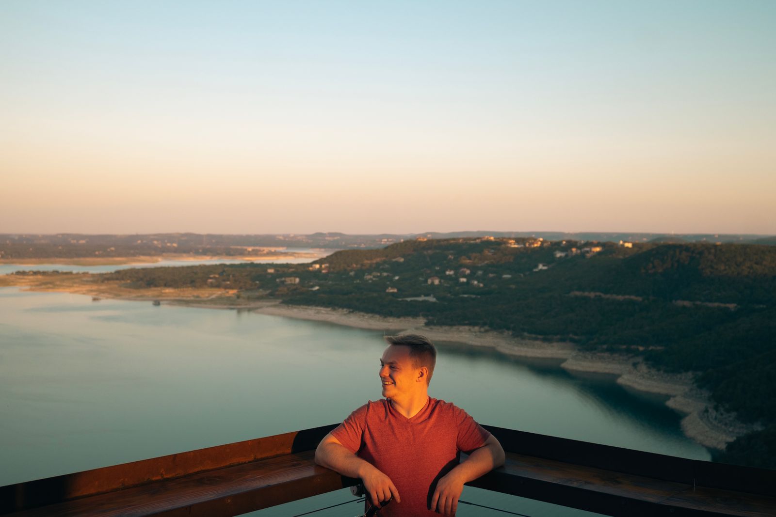 A photo of a man with a Lake Travis behind him