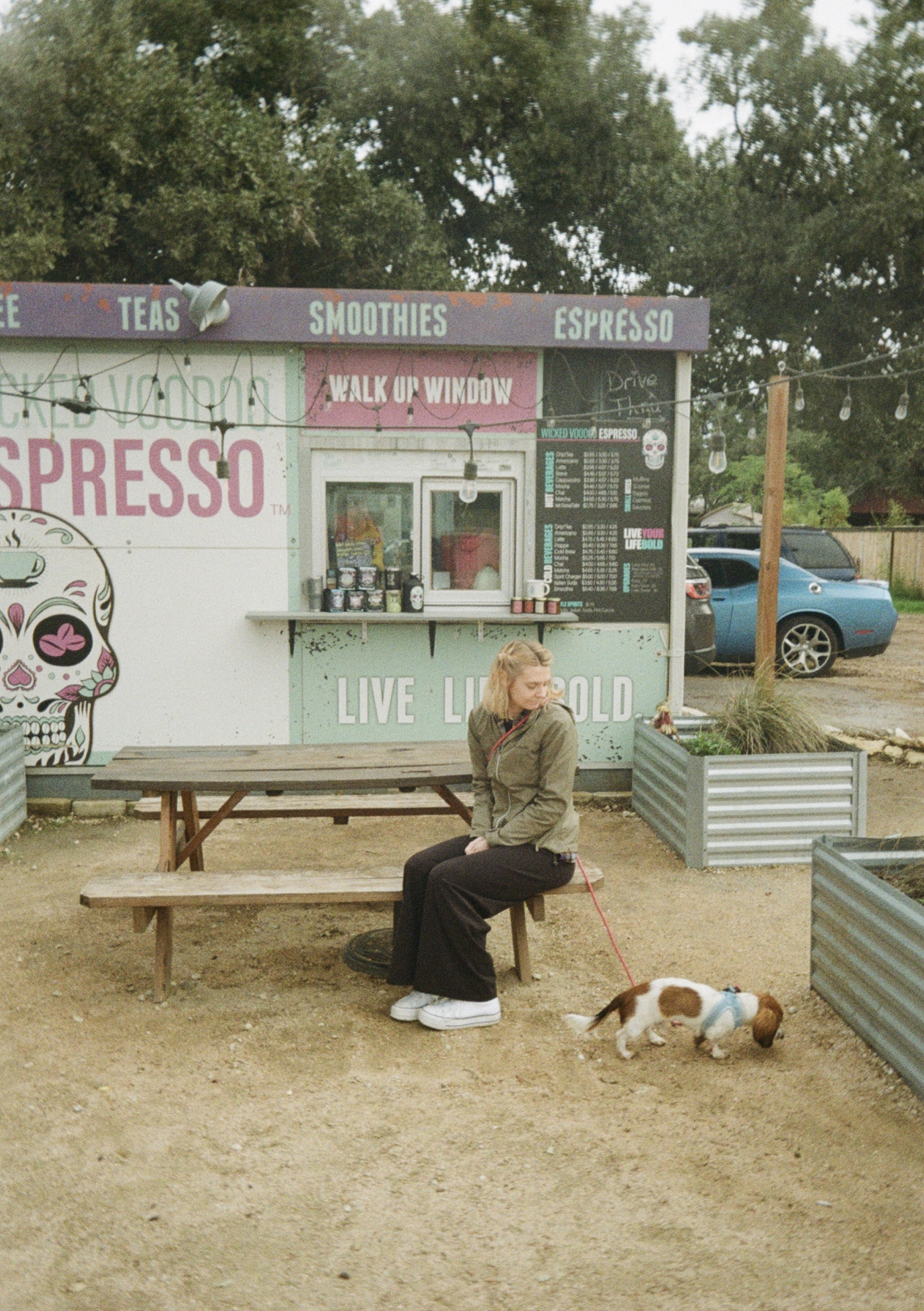 My wife and dog sitting in front of a coffee shop