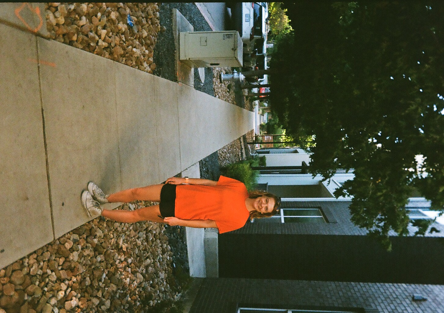 My wife standing outside our apartment building