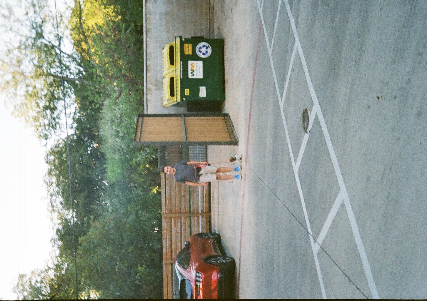 Me walking with our dog, next to a dumpster