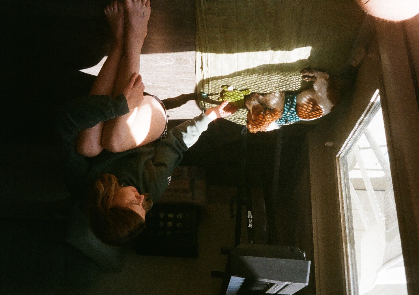 My wife and dog sitting in the sunlight, inside our apartment